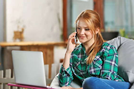 woman on phone wearing plaid